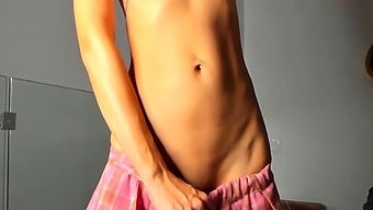 Curly teen with big tits uses a dildo for masturbation